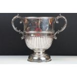 Early 20th Century silver hallmarked trophy having scrolled foliate handles, with a gadrooned body