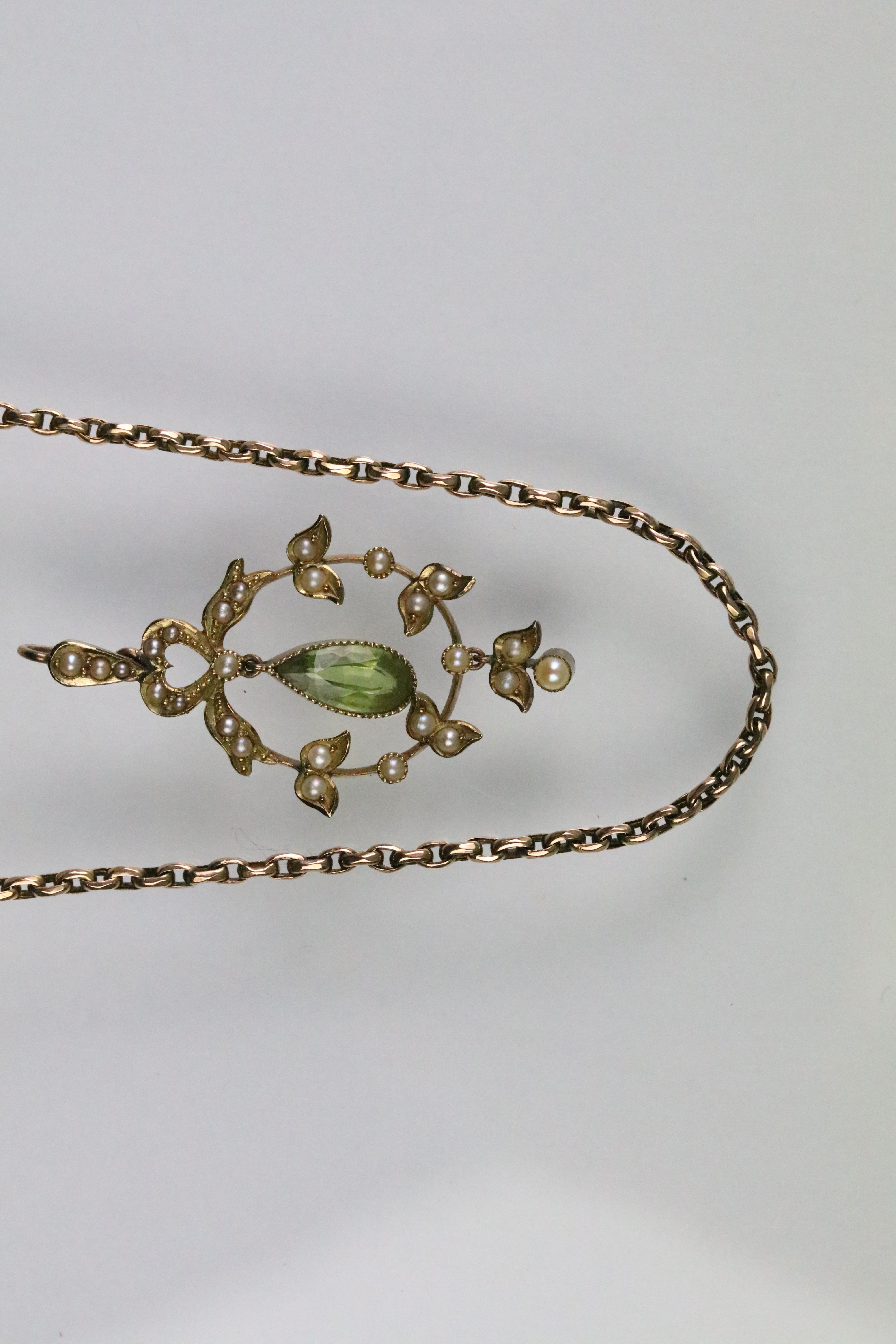 Early 20th Century Edwardian 15ct gold peridot and seed pearl pendant having an open work foliate