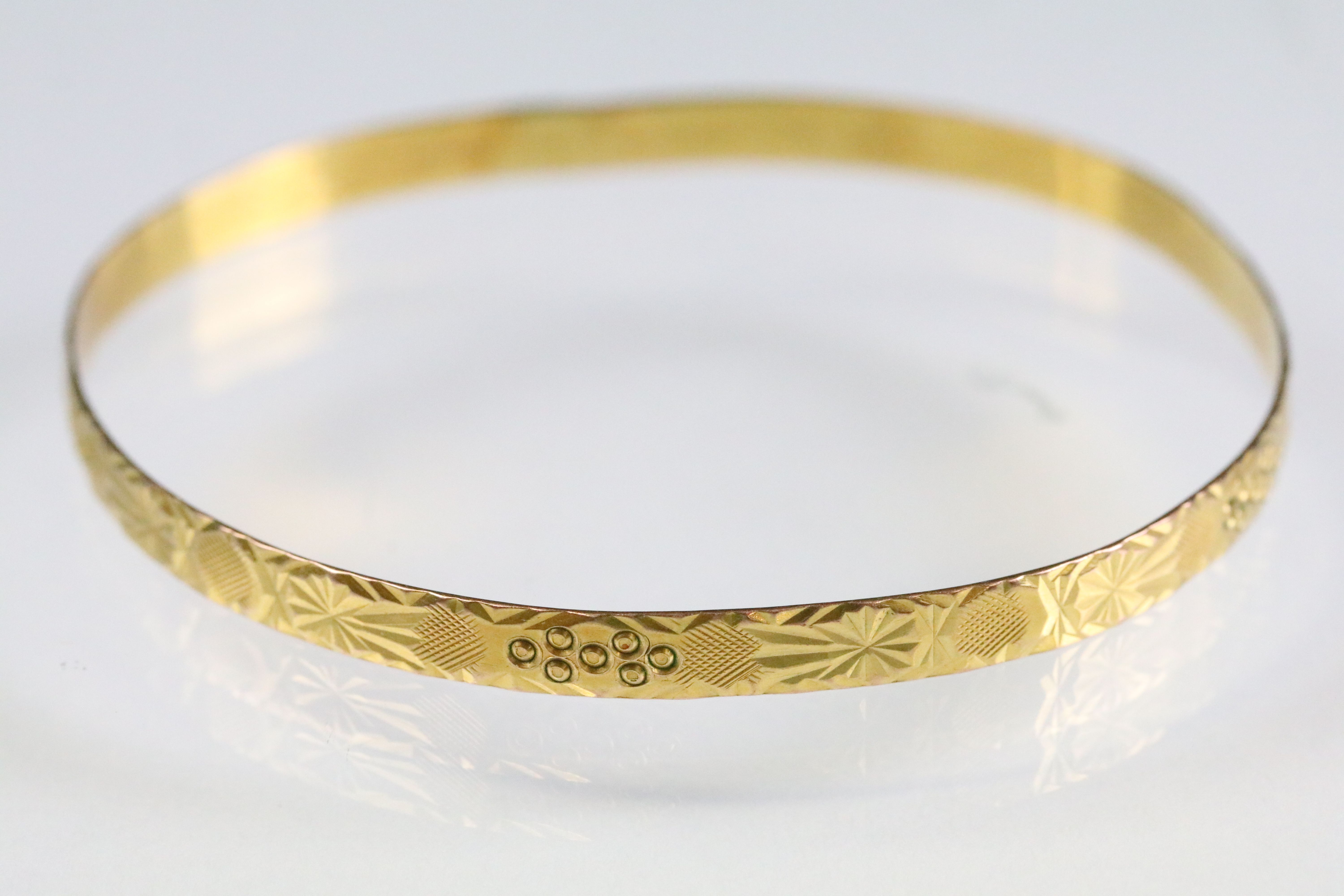Incised closed bangle bracelet with geometric details. Yellow metal marked 22. Measures 6cm wide. - Image 2 of 4