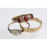 Three 9ct gold rings to include a 9ct and platinum Art Deco ring (size O), red paste three stone