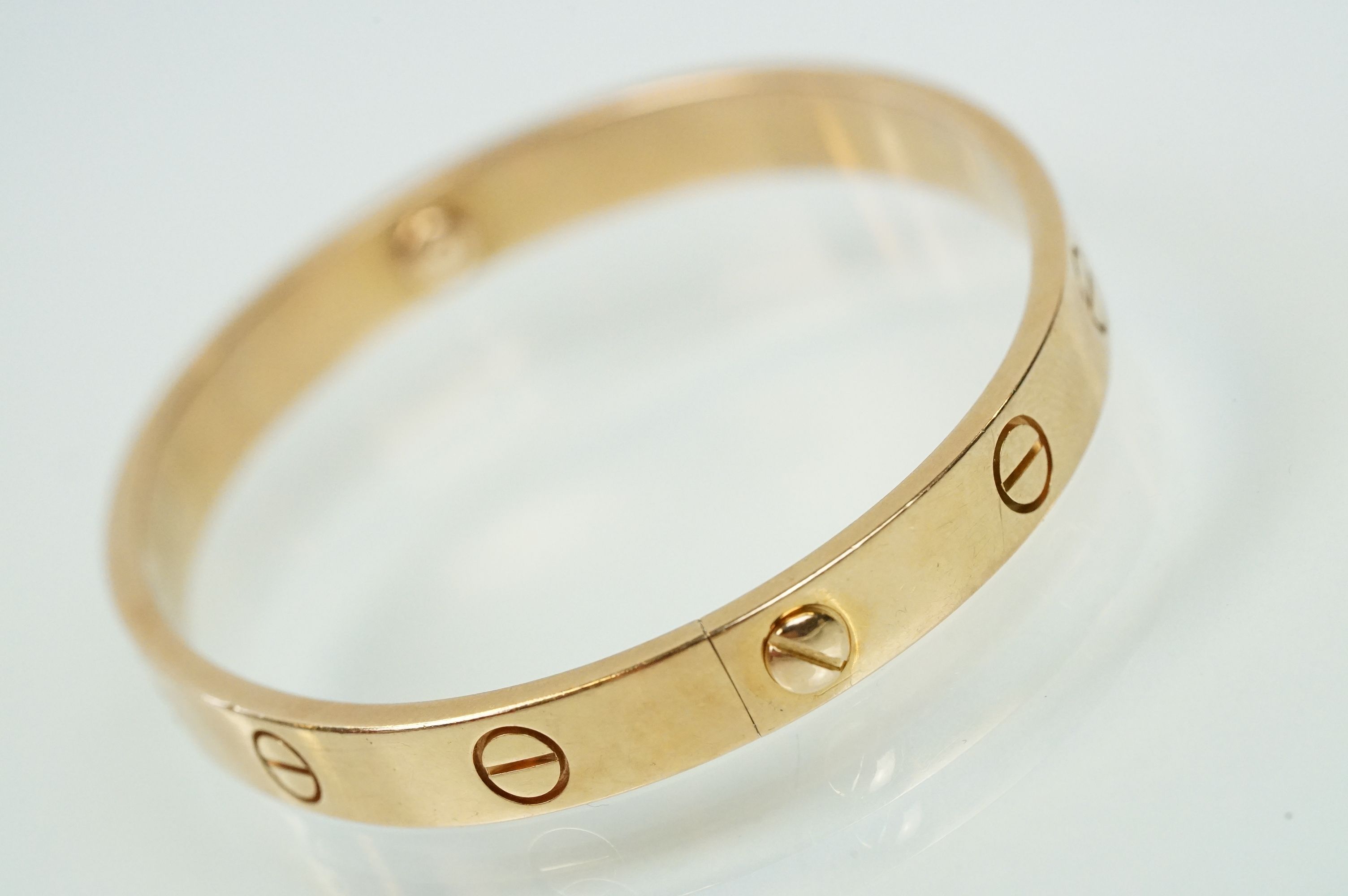 Cartier - 18ct gold 'love' bangle bracelet of oval form with screw detailing. Signed Cartier with - Image 5 of 11