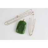 Carved nephrite pendant with 18ct gold bale together with two 9ct gold necklace chains. Nephrite