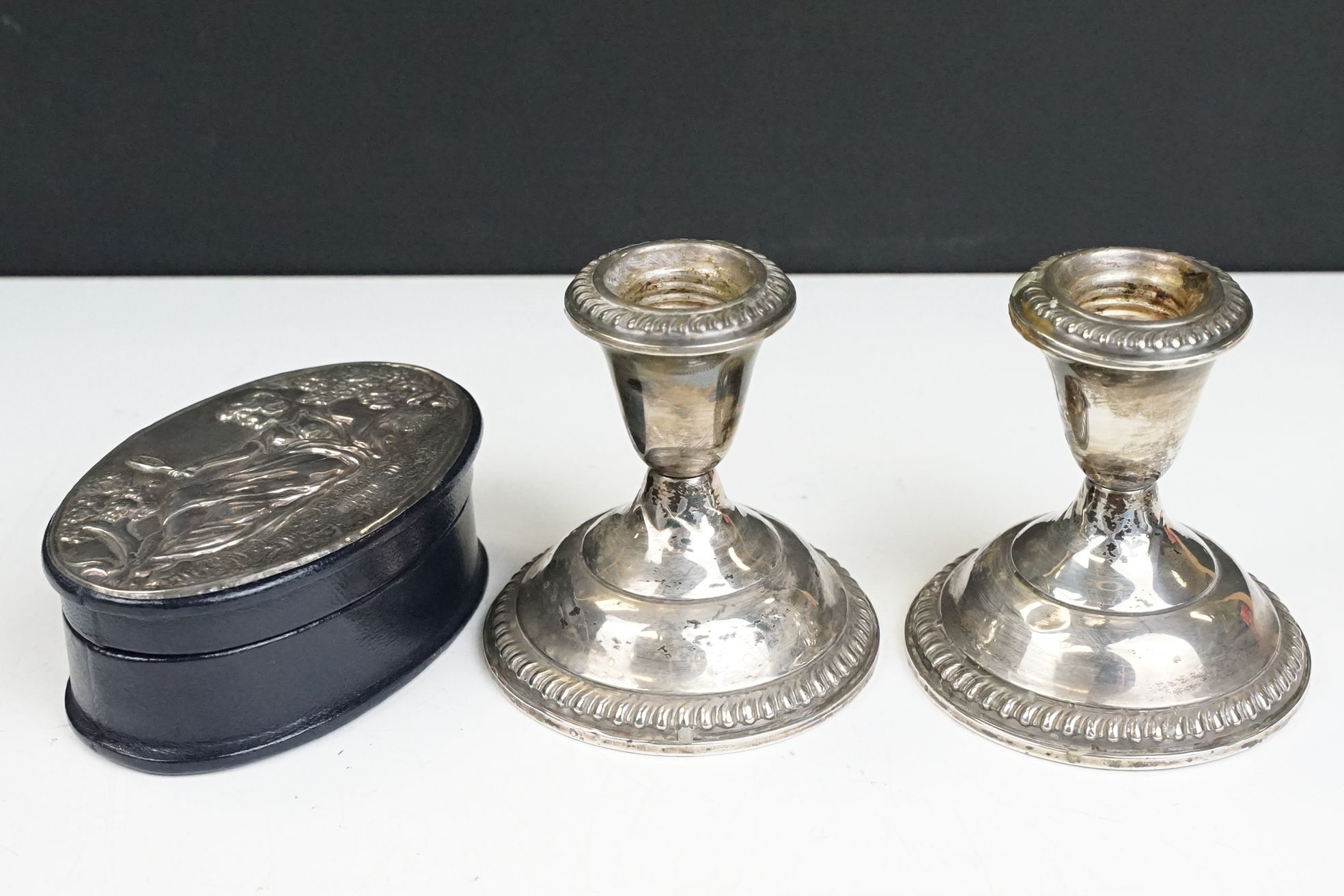 Pair of Empire Sterling weighted candle sticks with gadrooned borders together with a leather box