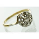 Early 20th Century 18ct gold and diamond target ring. The ring having a open work round head set
