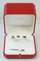 Cartier - 18ct gold 'love' bangle bracelet of oval form with screw detailing. Signed Cartier with