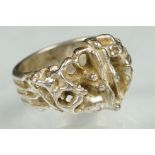 Scandinavian silver brutalist ring having an organic form head with pierced details. Marked 925S,