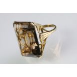 9ct gold and smoky quartz dress ring. The ring being set with a large step cut quartz set within a