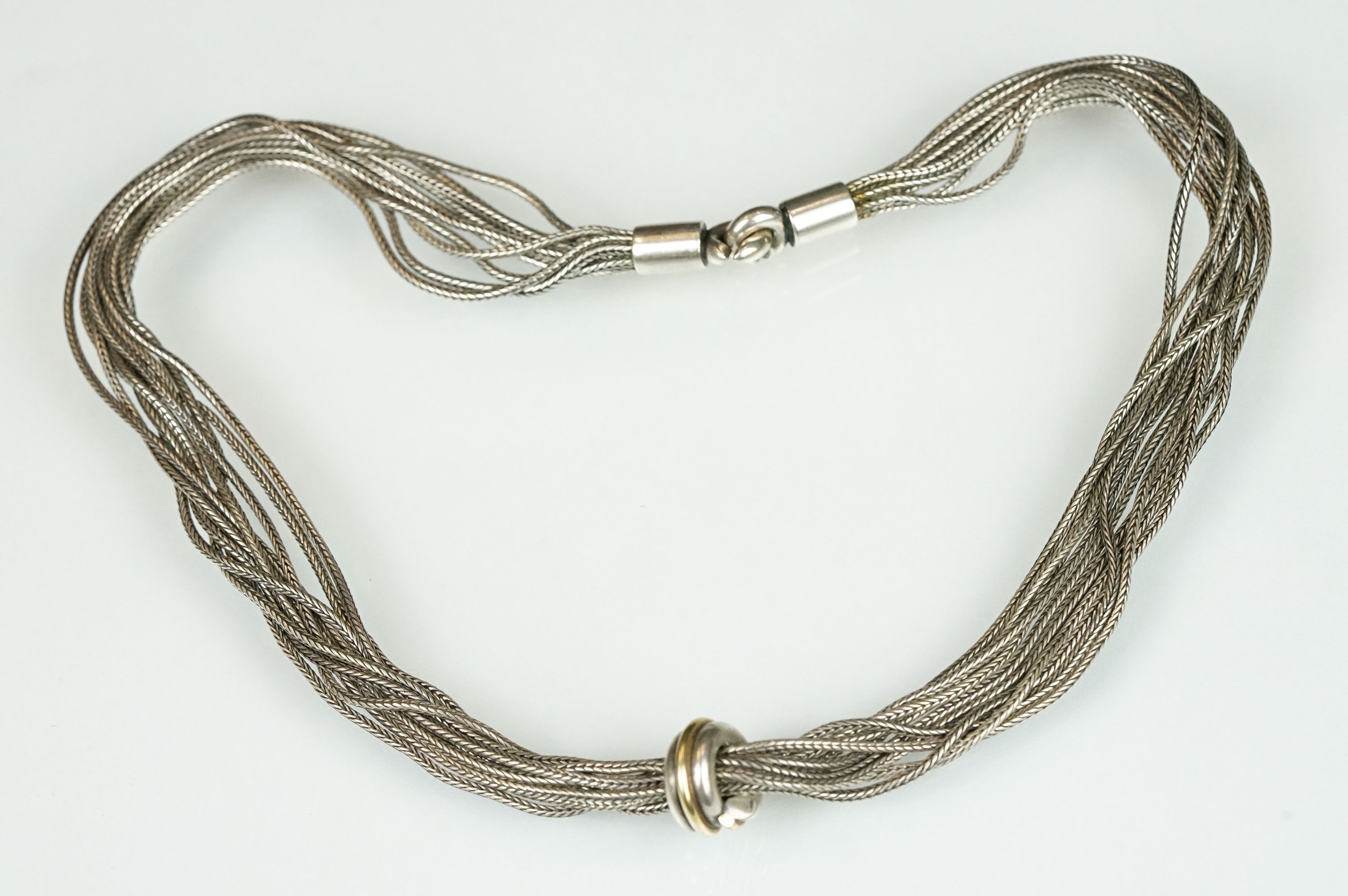 Scandinavian silver multi chain necklace having ten wheat link chains with knot design pendant to