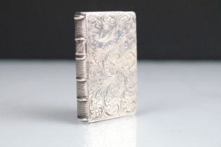 Early Victorian silver novelty vinaigrette in the form of a book having engraved scrolled