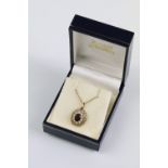 9ct gold garnet and pearl pendant necklace. The necklace having a fine link chain with pierced