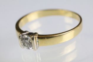 18ct gold and diamond solitaire ring having a round brilliant cut diamond channel set to head on a