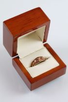 Clogau two tone 9ct gold ring having a pierced foliate knot to head set with diamond accent