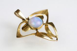 Early 20th Century Art Nouveau 9ct gold and opal pendant of whiplash form with a round opal cabochon