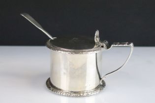 19th Century Victorian silver hallmarked mustard pot having a stirrup handle with floral moulded