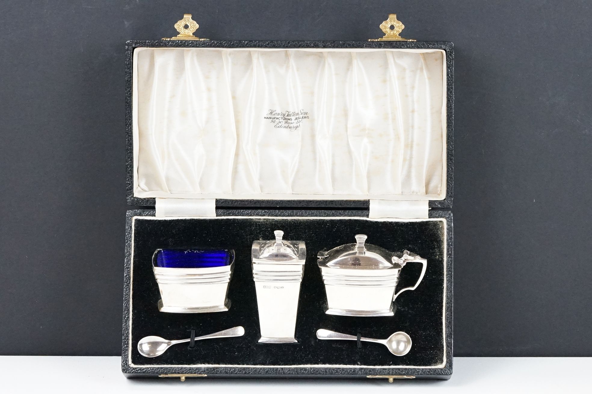 A fully hallmarked sterling silver Art Deco cruet set to include salt pot, mustard pot and pepper