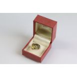 18ct gold, emerald and diamond leopard ring having enamelled details with round cut diamonds set