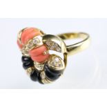 18ct gold diamond, coral and onyx dress ring. The ring having carved panels of coral and onyx in