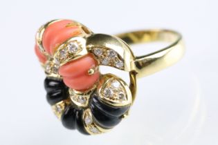 18ct gold diamond, coral and onyx dress ring. The ring having carved panels of coral and onyx in