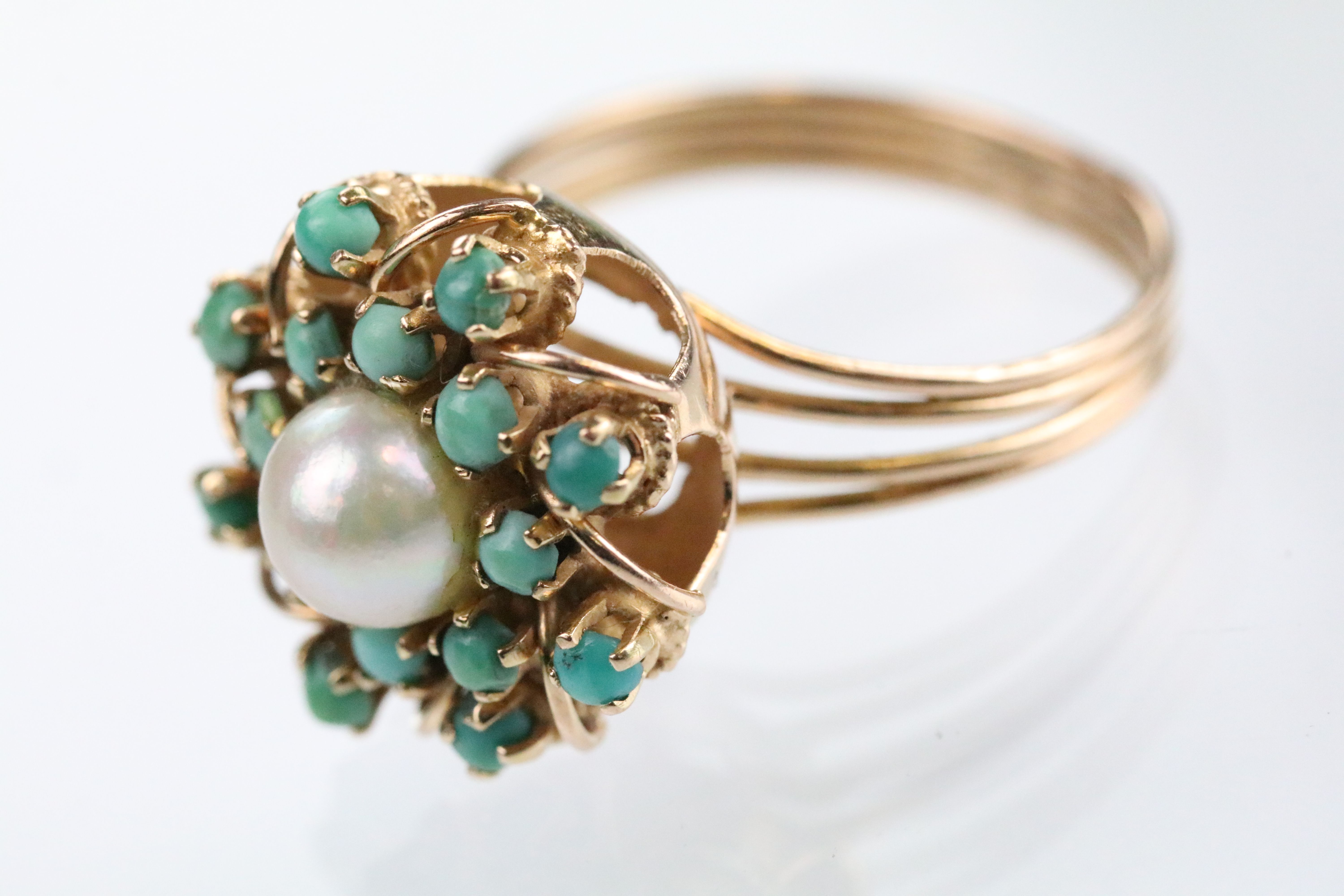 Cultured pearl and turquoise cluster ring having a half pearl set to centre surrounded by green