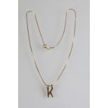 9ct gold hallmarked 'K' initial pendant necklace having a fine link chain with spring ring clasp.