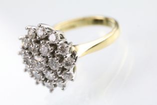 18ct gold and diamond nineteen stone diamond cluster ring. The ring being set with a central diamond