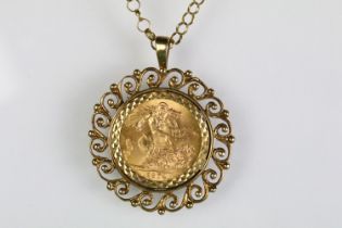 1974 sovereign set within a 9ct gold scrolled pendant mount set to a 9ct gold round link chain.