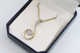18ct gold and diamond pendant necklace. The pendant of swirl design being set with a round fancy cut