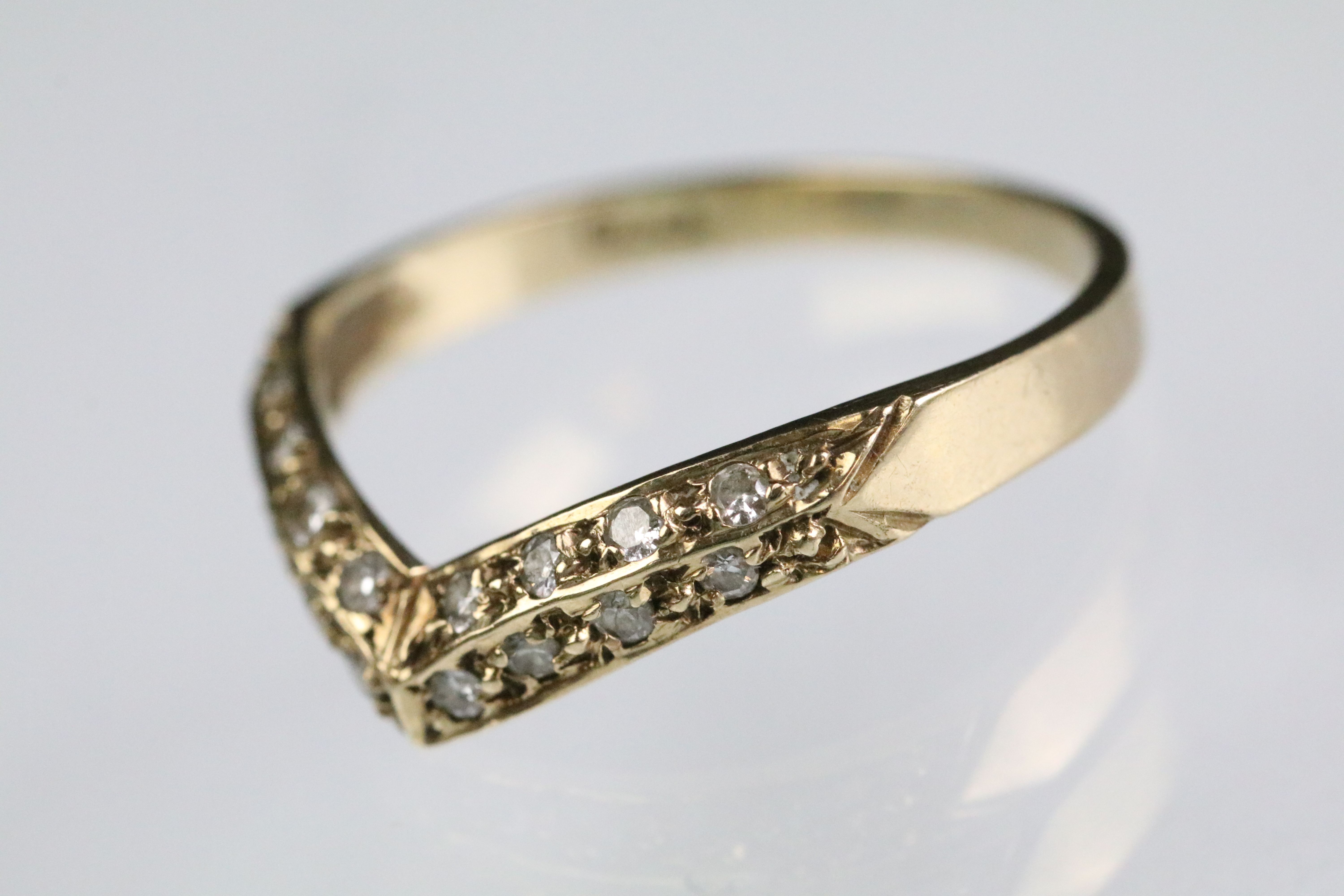 9ct gold hallmarked wishbone ring set with round cut diamonds throughout. Hallmarked London 1988.