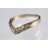 9ct gold hallmarked wishbone ring set with round cut diamonds throughout. Hallmarked London 1988.