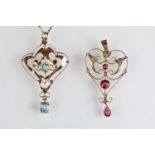 Two early 20th Century 9ct gold art nouveau open work pendants to include one blue and one red stone