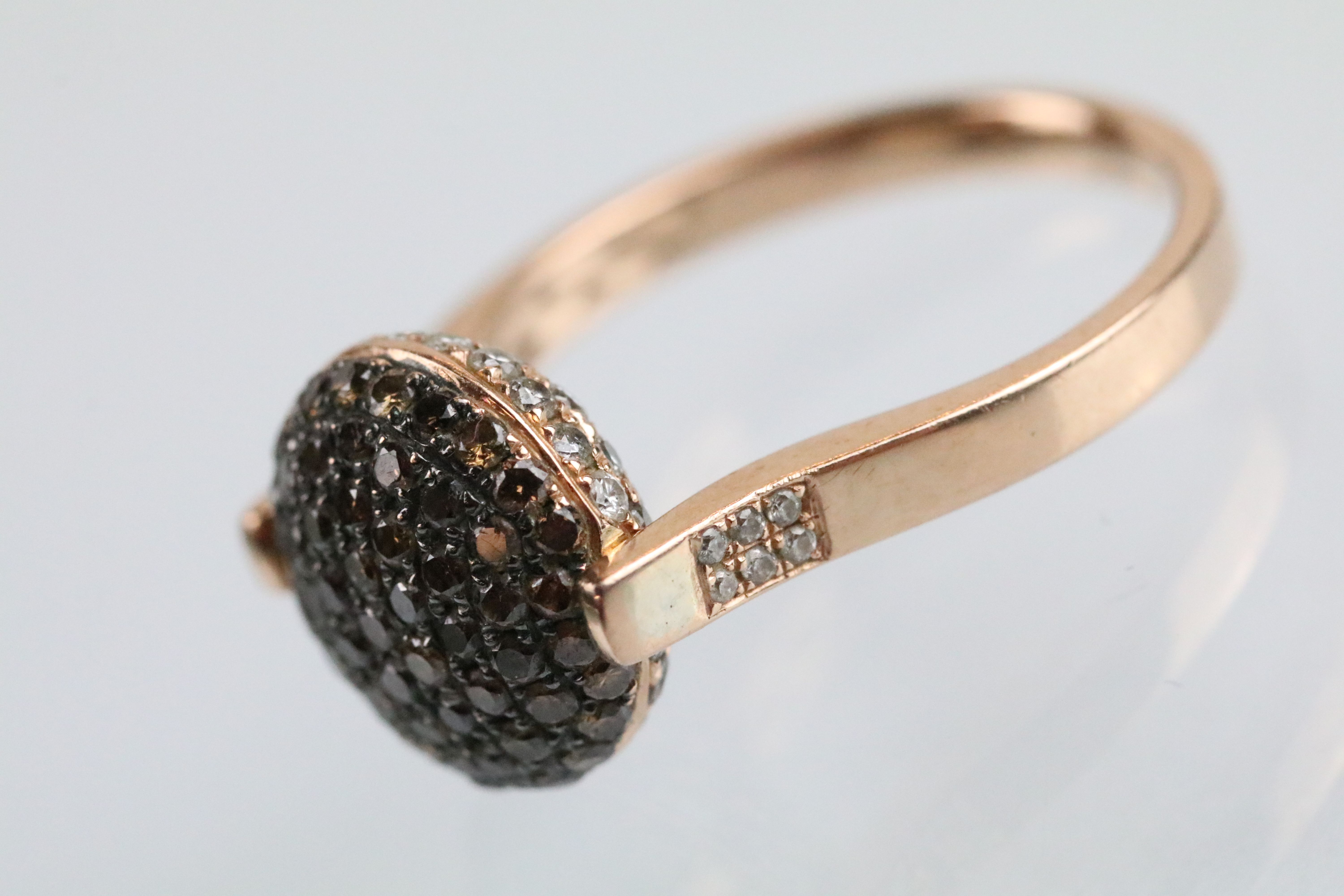 14ct gold and diamond swivel ring. The ring having a round head pave set with round cut diamonds