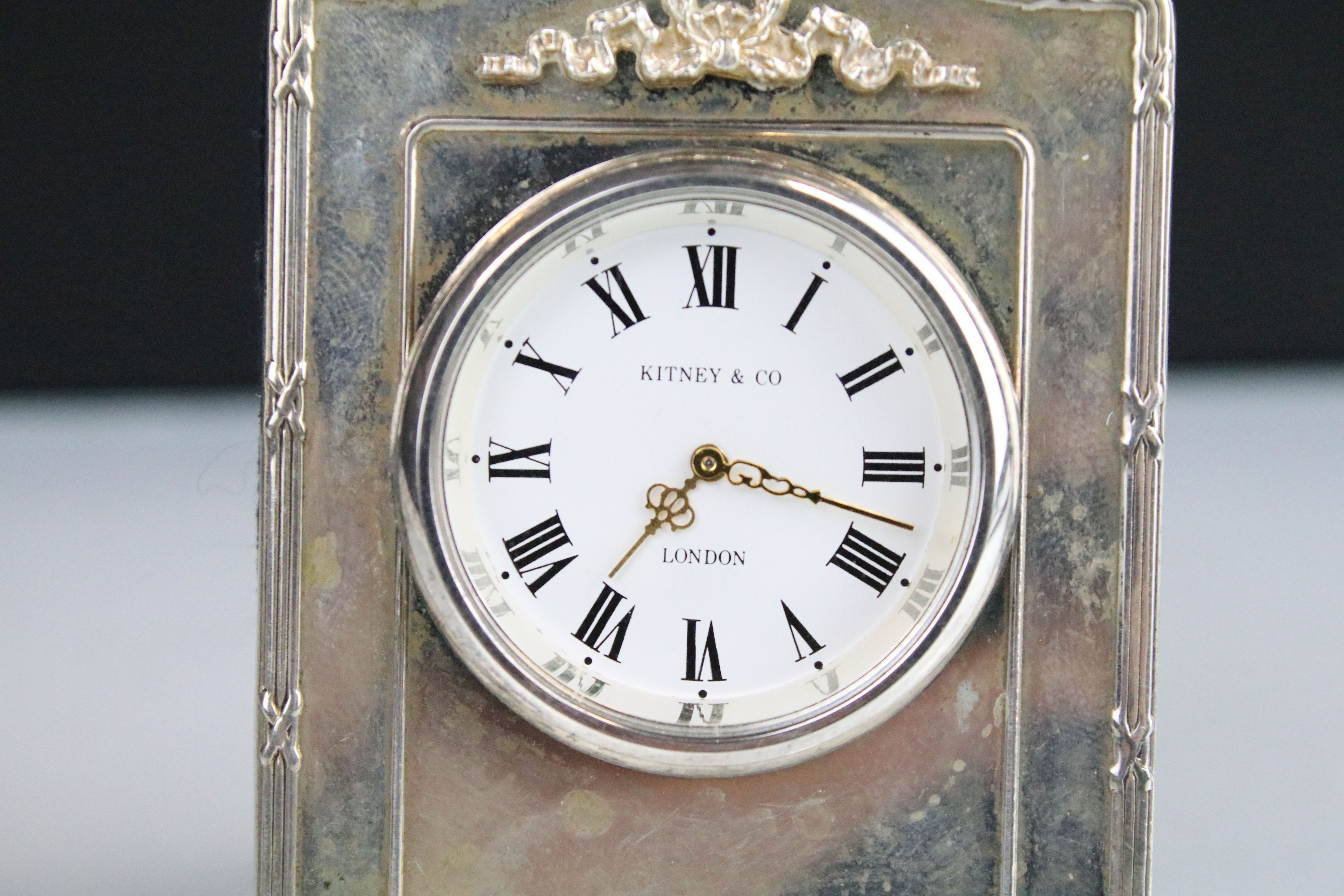 Kitney & Co silver fronted easel back clock timepiece having a round face with roman numerals to the - Image 2 of 3