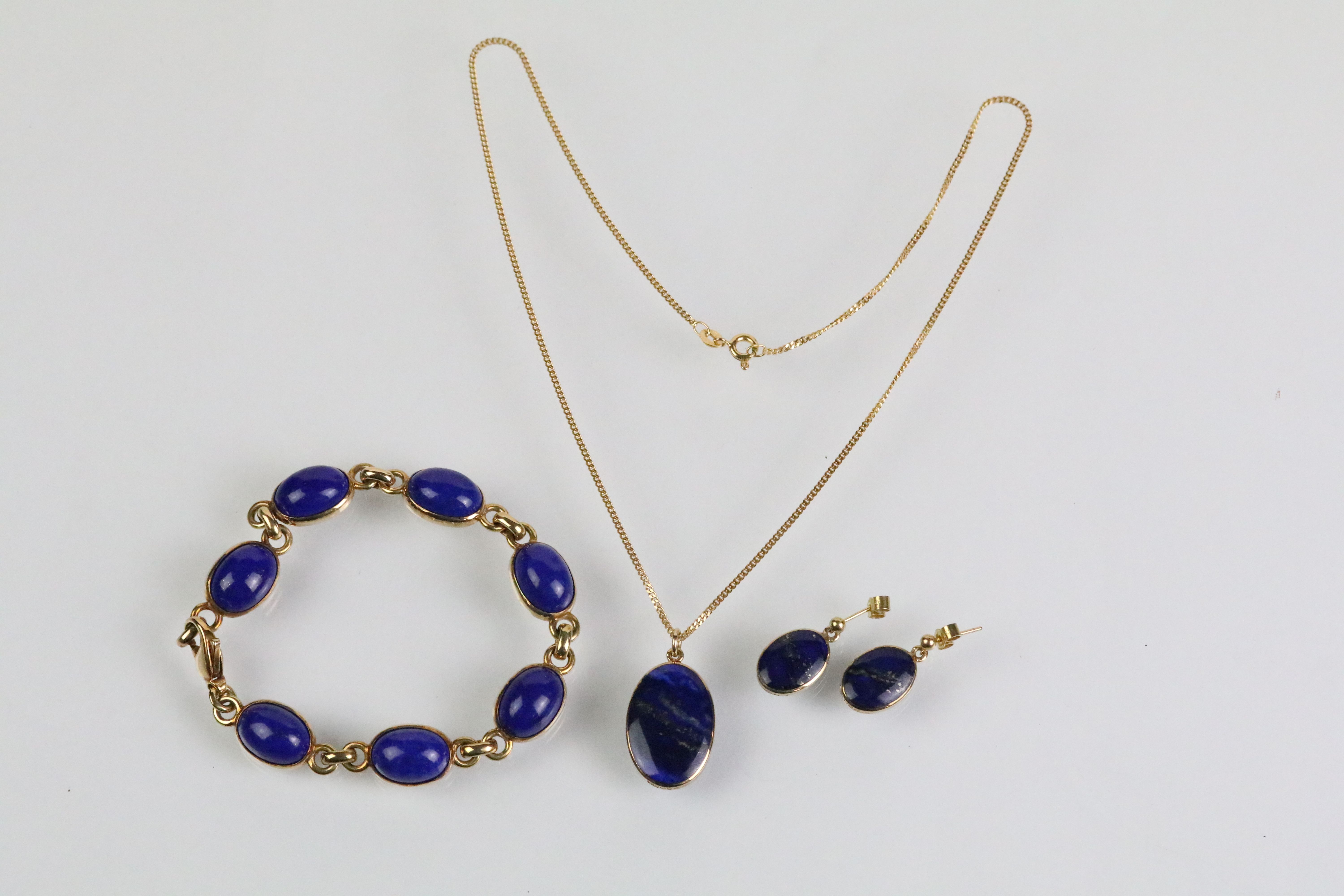 9ct and lapis lazuli necklace, bracelet and earrings. The bracelet set with seven lapis lazuli