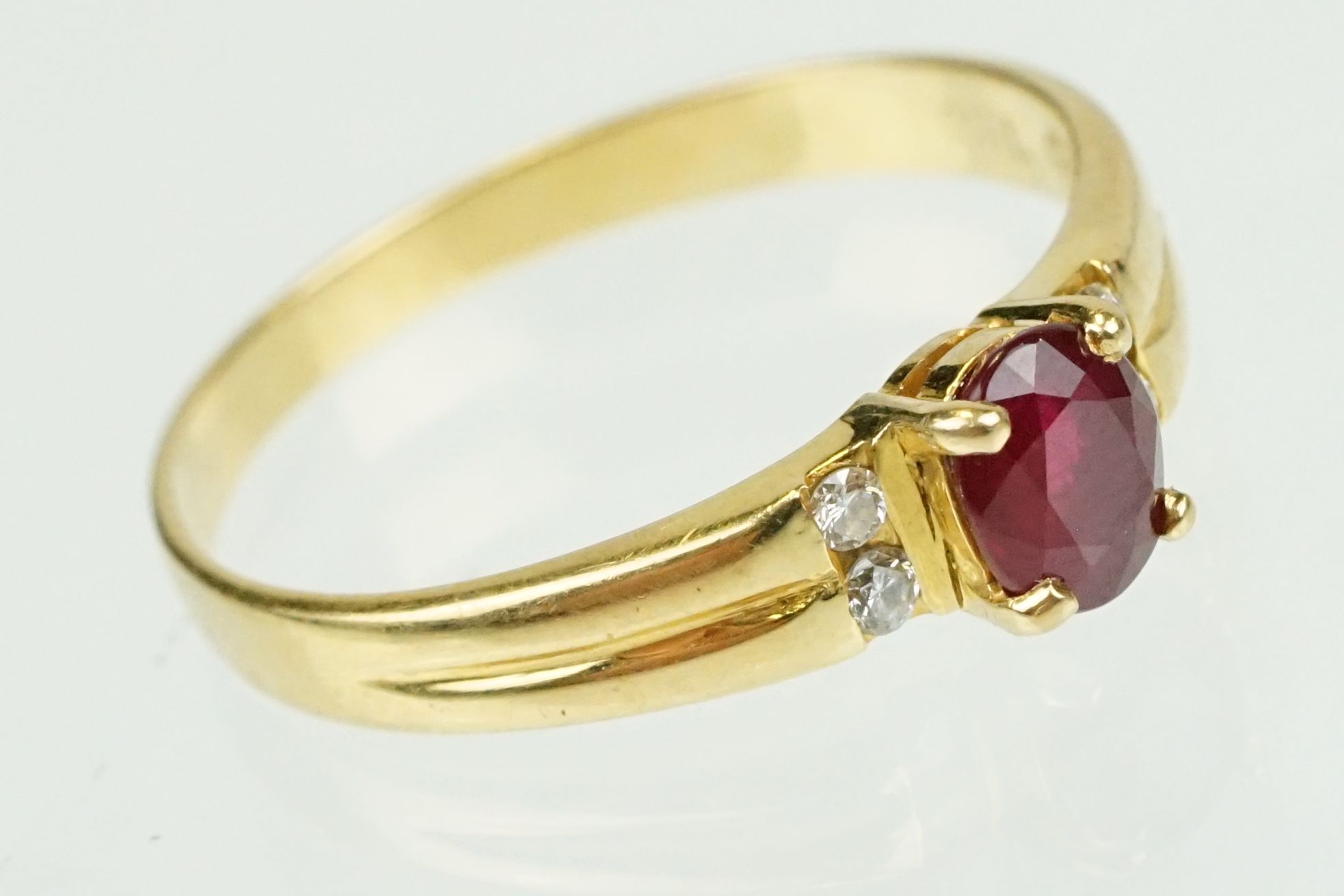 Ruby and diamond 18ct yellow gold ring, the oval mixed cut ruby measuring approx 5.5 x 4.5mm, claw