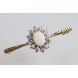 9ct gold opal and white stone bar brooch. The brooch being set with an oval opal cabochon to