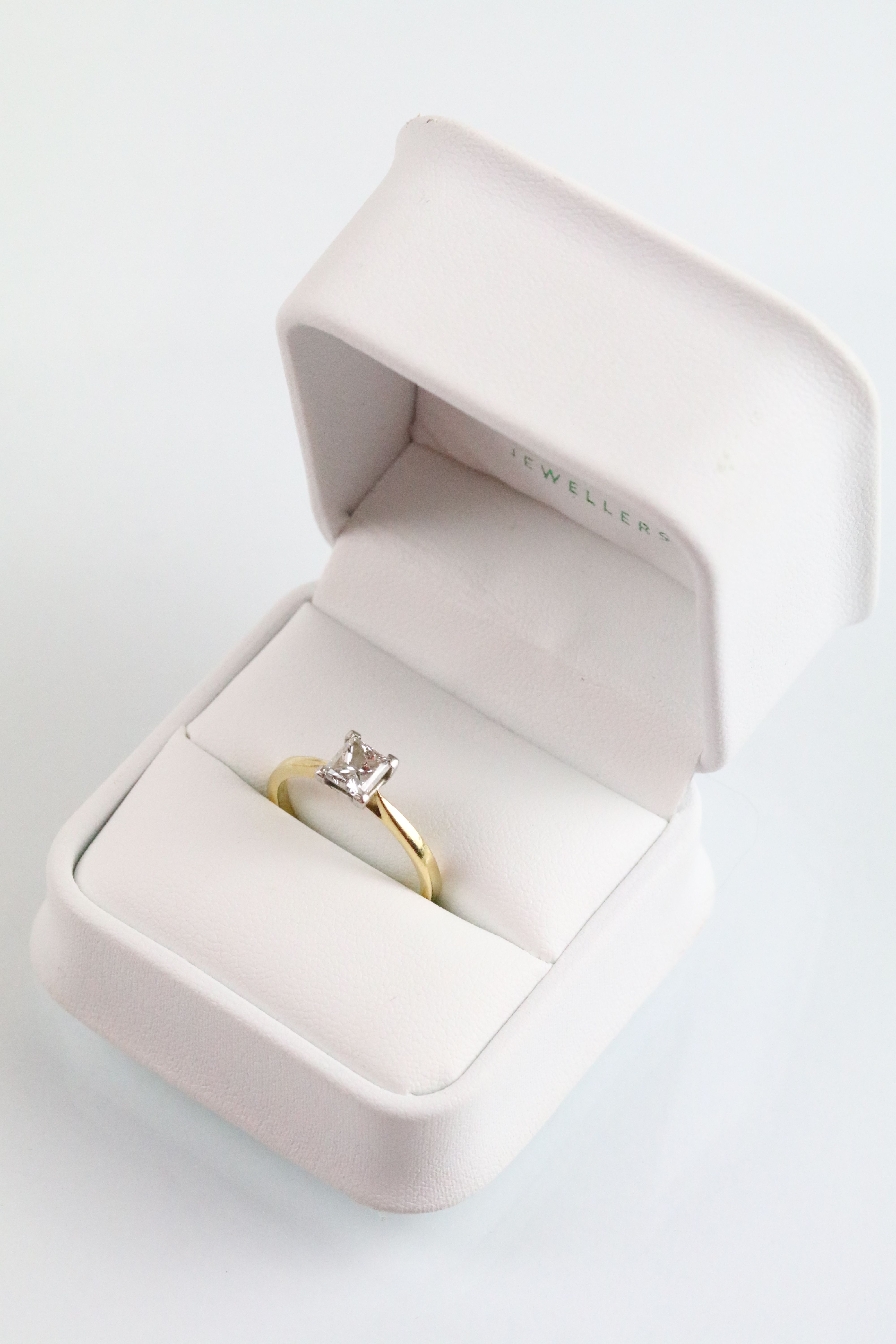 18ct gold and platinum diamond solitaire ring. The ring being set with a rectangular princess cut