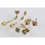 Three pairs of 9ct gold earrings to include a pair of emerald and diamond cluster earrings, pair