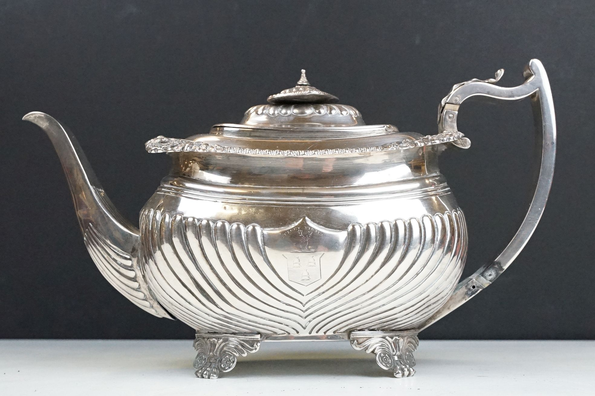 19th Century George III silver hallmarked teapot having a moulded shell and acorn borders, gadrooned