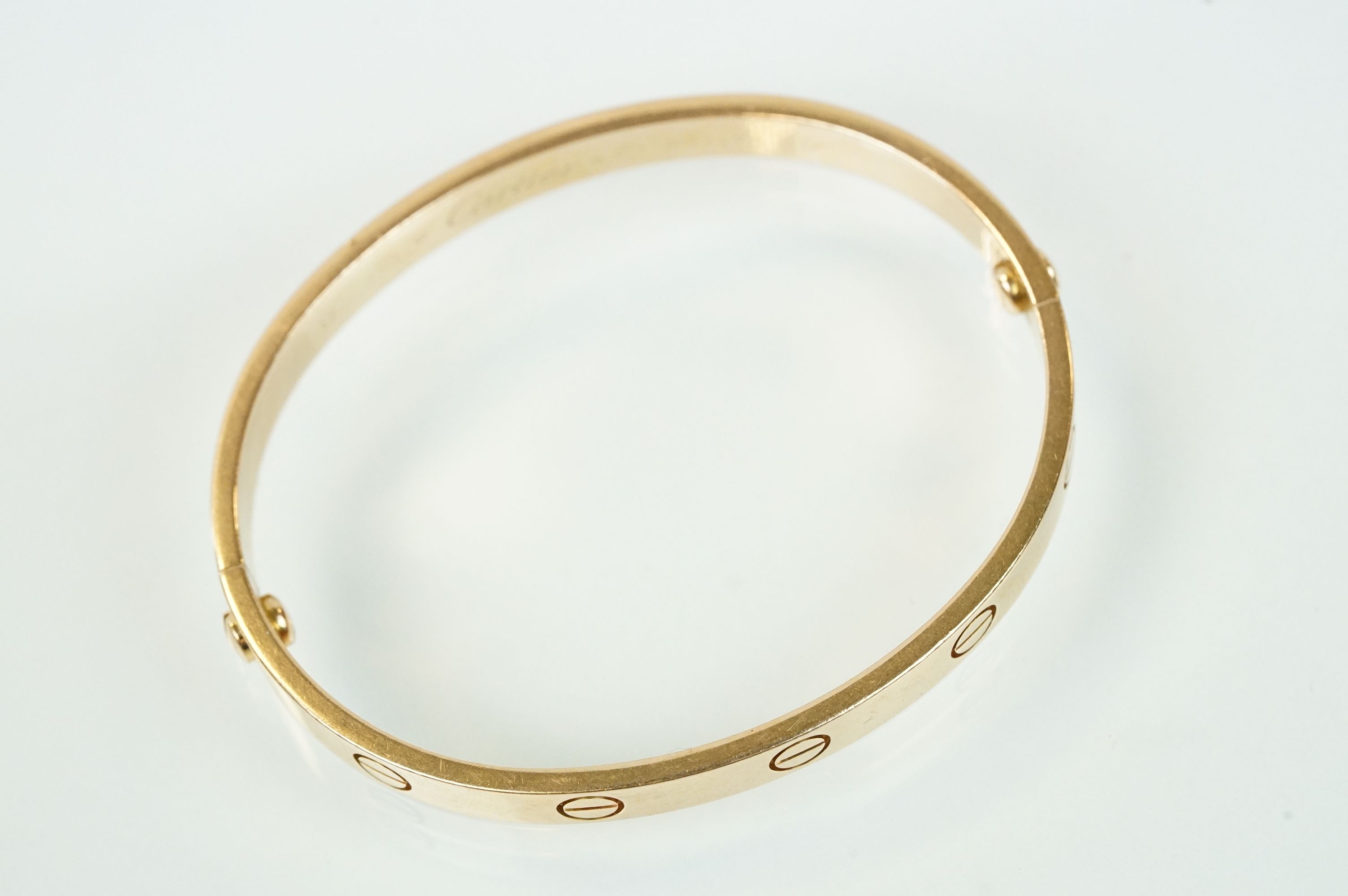 Cartier - 18ct gold 'love' bangle bracelet of oval form with screw detailing. Signed Cartier with - Image 6 of 11