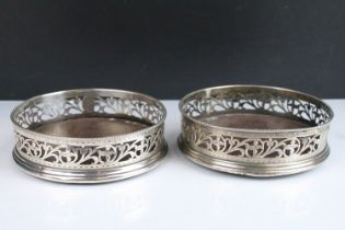 Pair of 19th Century George III silver hallmarked wine coasters having pierced foliate scrolls