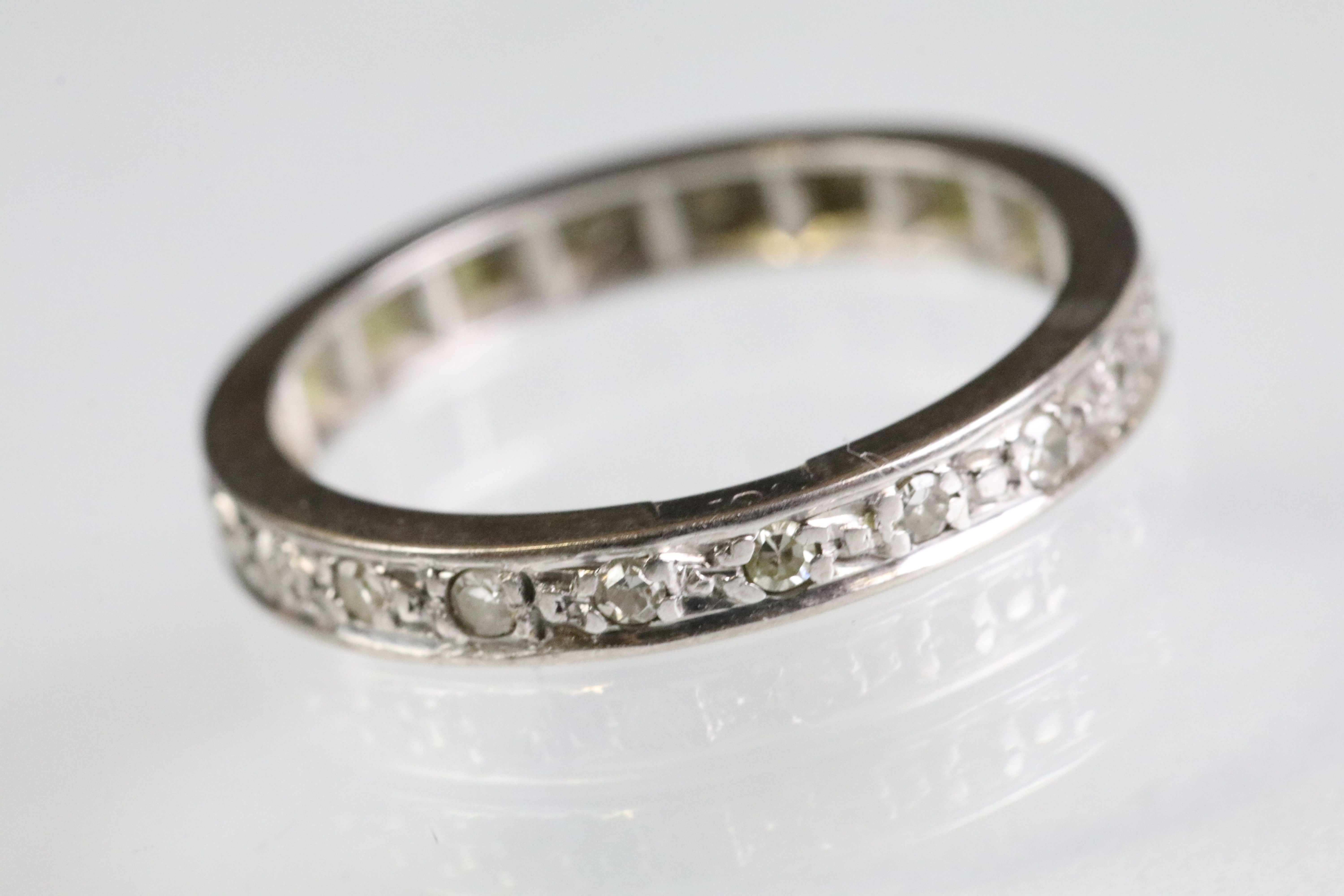 Diamond eternity ring being set throughout with round single cut diamonds. White metal unmarked,