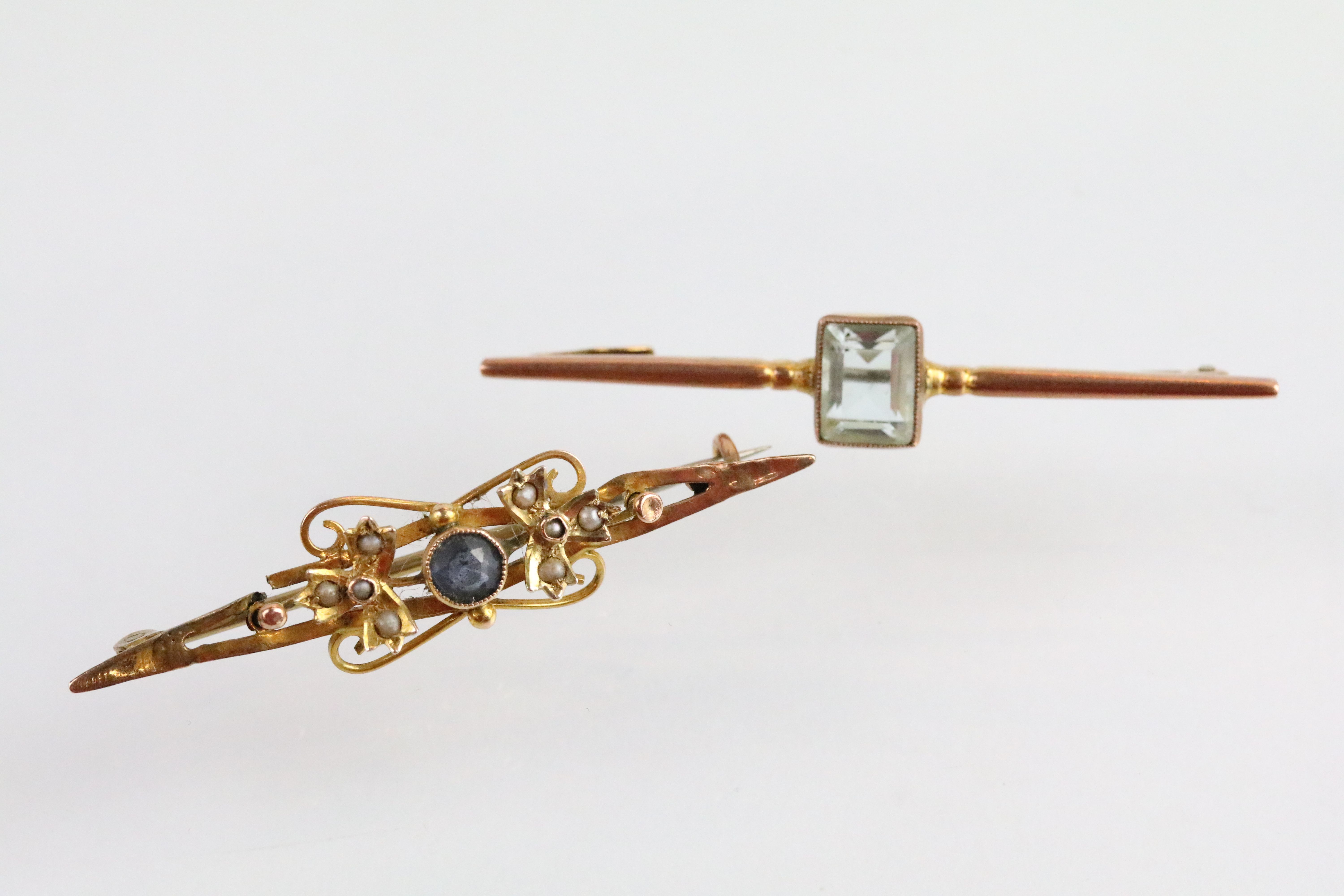 Two antique 9ct gold bar brooches to include a bar brooch set with a rectangular cut blue paste