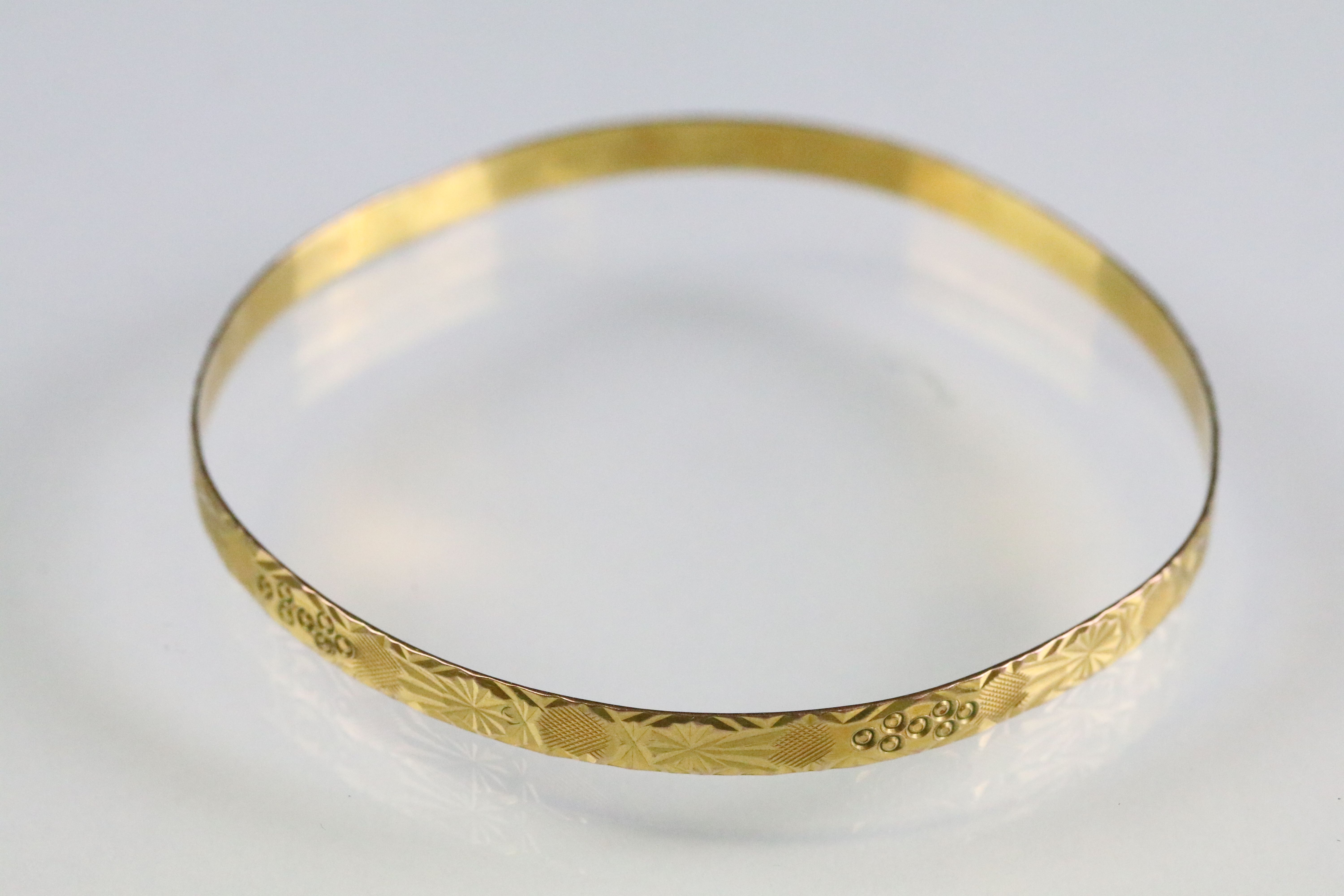 Incised closed bangle bracelet with geometric details. Yellow metal marked 22. Measures 6cm wide. - Image 3 of 4