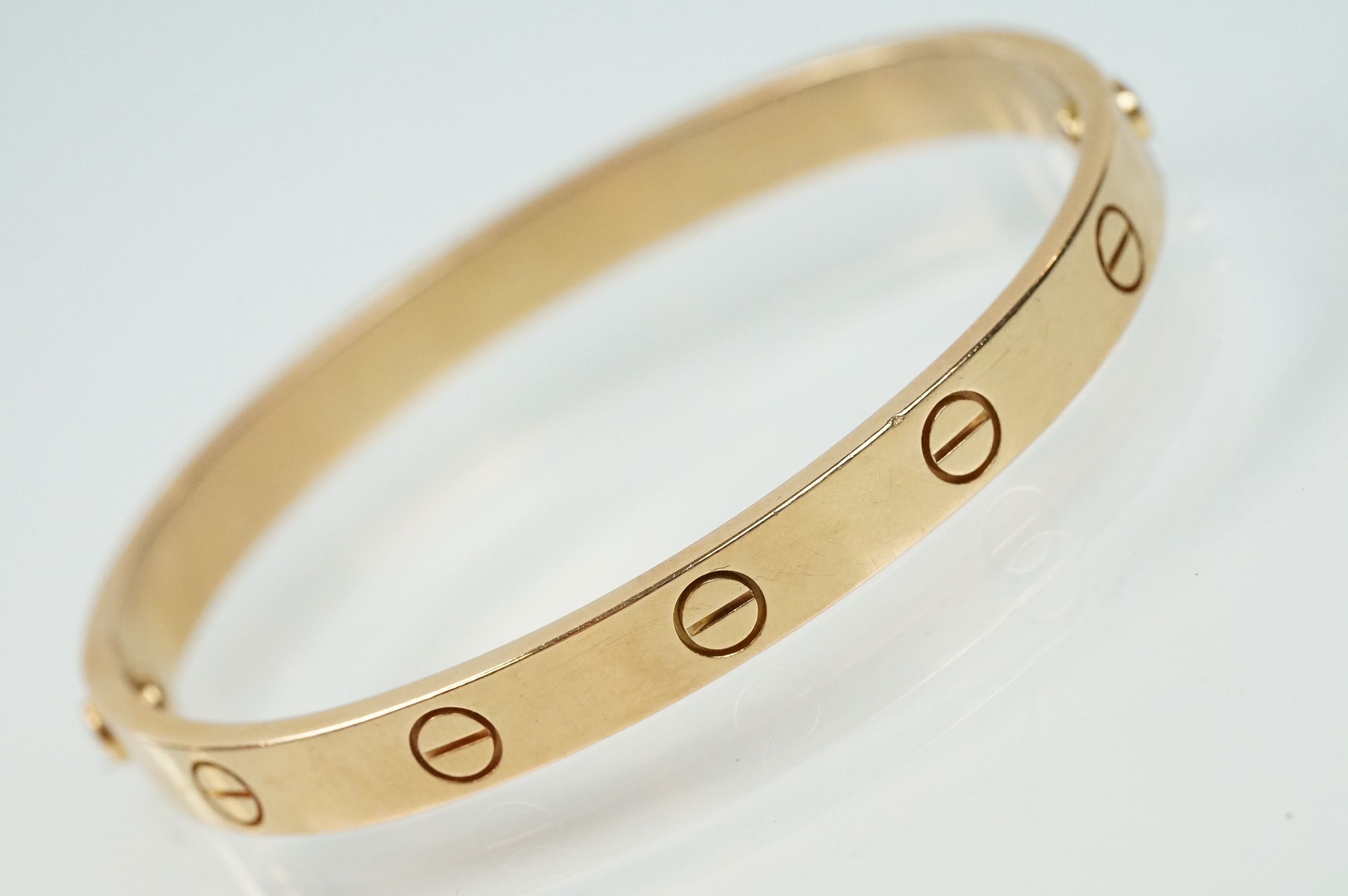 Cartier - 18ct gold 'love' bangle bracelet of oval form with screw detailing. Signed Cartier with - Image 4 of 11