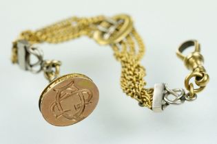 15ct gold pocket watch fob seal on chain. The fob having a two tone wire design mounted to four curb