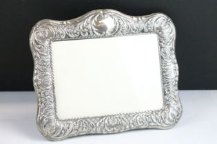 Silver fronted photo frame with moulded scrolled details and easel back. Hallmarked Sheffield