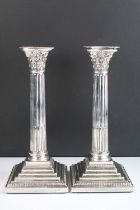 Pair of 19th Century Victorian silver candlesticks having square stepped bases with reeded columns