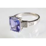 18ct gold tanzanite and diamond ring. The ring being set with a cushion cut tanzanite flanked 14
