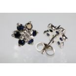 Sapphire and diamond cluster earrings having a central illusion cut diamond to centre with a hao