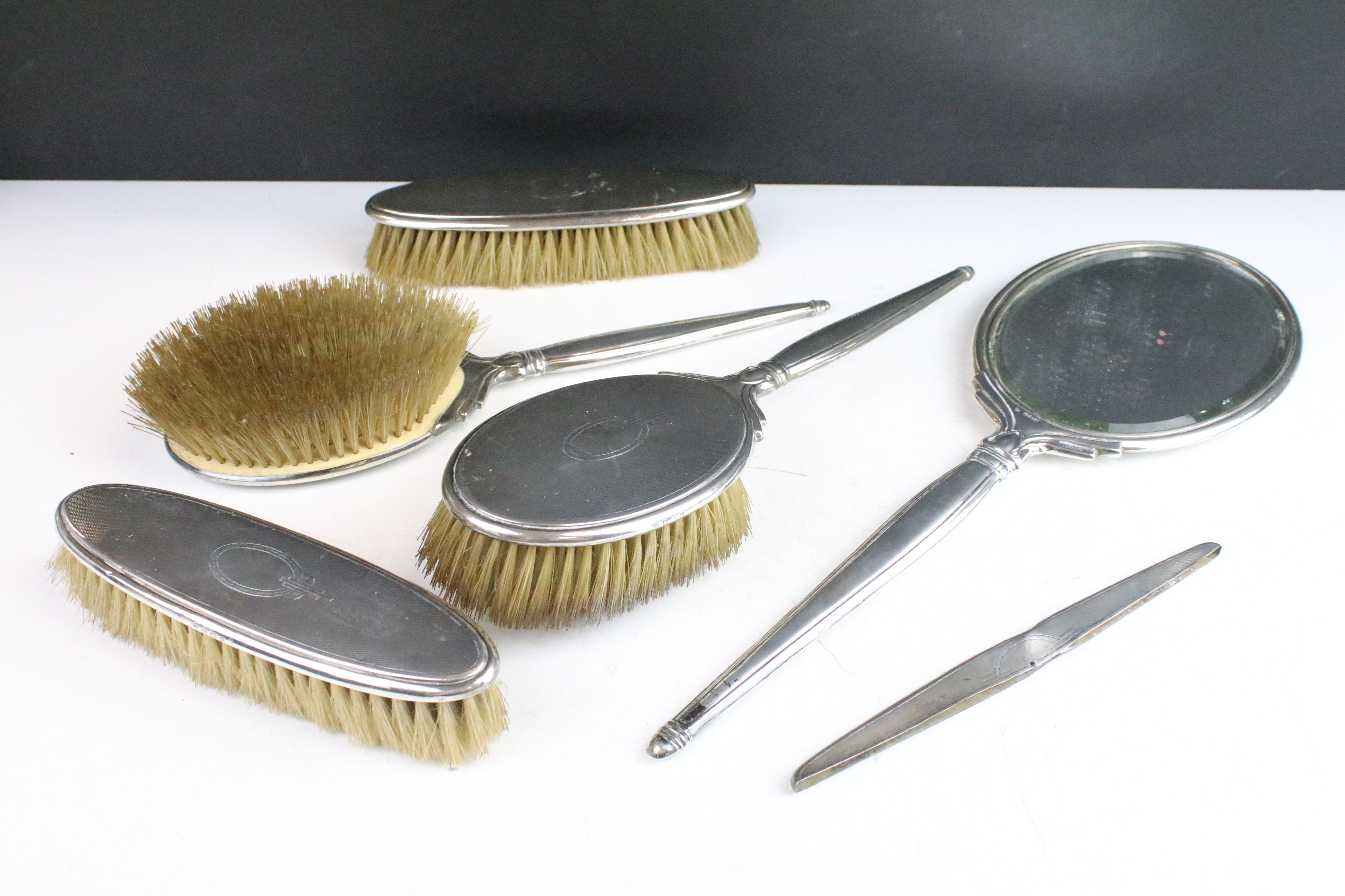 Art Deco silver hallmarked dressing table set consisting of mirror, two hair brushes and two clothes